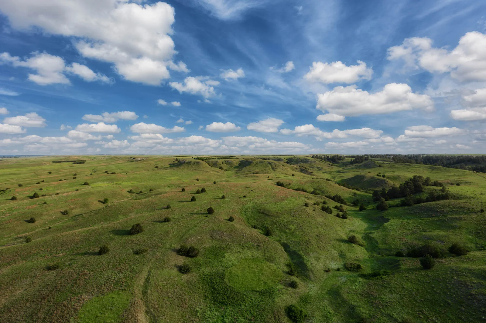 Aerial drone photo of rolling Nebraska Sandhills under a blue sky
